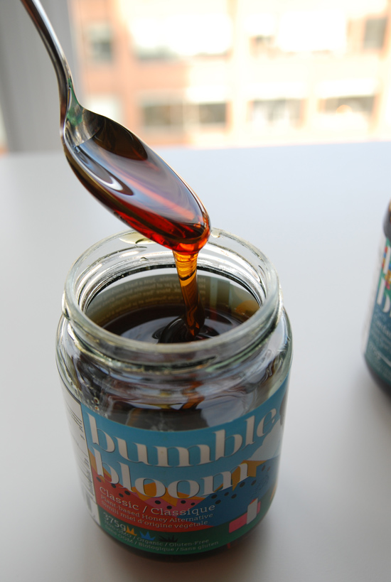 Bumble Bloom Vegan Honey Alternative dripping from spoon into jar