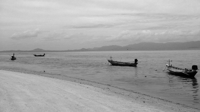 Fishing boats in Thailand near the shore.