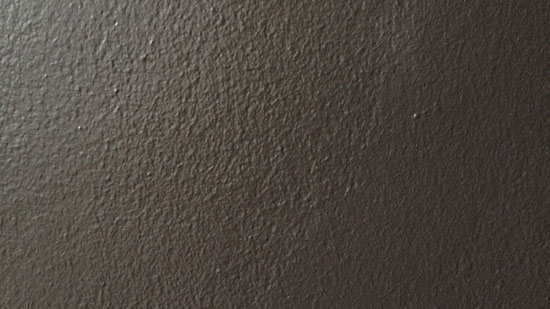 Photo of a grey wall with speckled texture.