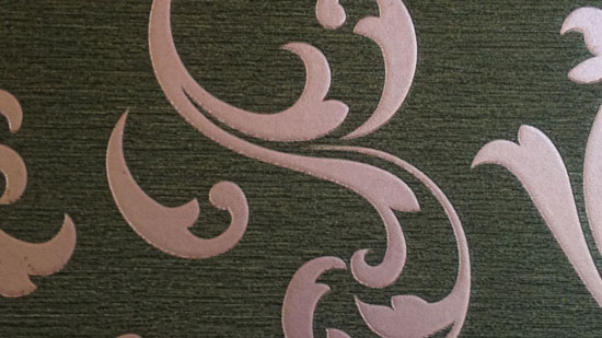 Photo contains light pink swirls on a dark grey background.