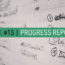 Image contains a notepad with illegible text in black ink and a pen on the left-hand side. In the foreground, there is text in the middle of the screen on a strip of light green that says "T.O.F.U. #15 |" in black and "Progress Report #2" in white.